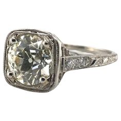 an old cut diamond ring with filigrees and diamonds on the sides, set in