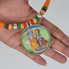 Weight- 28.5 Grams Approx 2 In 1 Pendant Necklace Double side Silver Hand Painting Pendant Necklace One side God Ganesha Painting & back side God Radha Krishna Painting Hindu Indian Necklace Handmade Pendant 92.5 Silver one side Ganesha Pendant Miniature Painting and second side Hindu God Radha Krishna Hand Painting, Glass Framed Pendant With Silver Lock Primary Color of Pendant is Silver. Necklace Thread Colour- Red Orange and Green beautiful combination of colour. Weight of Necklace- Approx 80 Gram Covered by silver and glass. Used natural water colours on paper sheet. It's a totally handmade hand Painted Miniature Painting Hindu Deity Pendant from Rajasthan. Artistic Jewelry With Artistic Design For Festivals, Multicolor Necklaces For Puja, Artistic Design Necklaces For Festivals, Artistic Silver Jewelry For Festivals, Artistic Multicolor Jewelry For Festivals, Hand Painted Jewelry For Festivals, Artistic Multicolor Jewelry For Wedding, Artistic Multicolor Festival Jewelry, Artistic Multicolor Wedding Jewelry