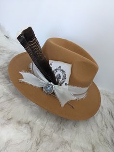 Custom Concho Hat Band Set! Personalize your favorite hat with this unique custom hat accessories set.  The easiest way to customize your favorite hat. Set includes *42" Cream Chiffon Ribbon, Tan Suede Cord 30", *Ace playing Card, *Natural Feather (8-9" long)  and *Concho Style Broch Pin. Use this custom hat set to add to your favorite Western Hat, Fedora, Wide Brim Hat or Cowboy Hat Everything included but the hat. Hat Not included Please note: Due to the handmade nature of these size and color Customizable Brown Hat With Flat Brim, Customizable Brown Flat Brim Hat, Adjustable Wide Brim Fedora As Gift, Adjustable Wide Brim Hat For Gift, Adjustable Wide Brim Top Hat As Gift, Custom Short Brim Hat As Gift, Handmade Adjustable Top Hat As Gift, Bohemian Mini Hat With Short Brim For Gift, Bohemian Mini Hat With Short Brim As Gift