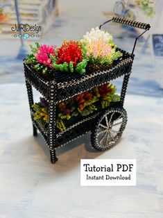 a small cart with flowers in it sitting on a table