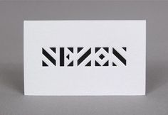 a white card with black and white geometric designs on the front that says,'new '