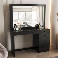 there is a vanity with many bottles on it and a couch in the back ground