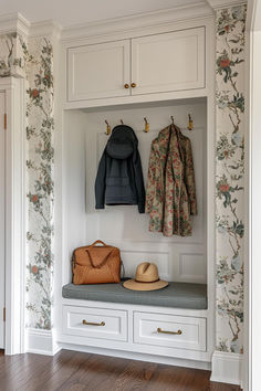 a coat rack with two coats hanging from it's hooks and some purses