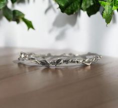 Leaf and Vine Twig Bangle Bracelet in Sterling Silver - Polished or Oxidized- by DV Jewelry Designs This bangle has 11 hand sculpted leaves with twig texture and vines plus tiny buds. The perfect everyday bracelet, beautiful worn alone or when stacked in multiples. Bangle Size:  Small- 2.25 (ID) inches in diameter Medium- 2.5 (ID) inches in diameter Large- 2.75 (ID) inches in diameter Thickness: 3mm to 6mm at widest point. Note: Made to Order, please allow 3-4 weeks to ship. This is for (ONE) Leaf & Twig Bangle. Multiple Bangles are available to purchase. Ships in a Black Velvet Bag with DV Tag Materials: Sterling Silver with Oxidation or without Oxidation Everyday Bracelet, Velvet Bag, Jewelry Designs, Bangle Bracelet, Vines, Bangle Bracelets, Jewelry Bracelets, Etsy Accessories, Jewelry Design