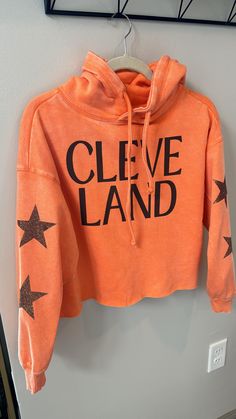 Ladies, Bright orange Browns Hoodie with sparkle brown star sleeve detail. Waist length crop sweatshirt; cleveland Browns crop sweatshirt Trendy Fall Hoodie With Star Print, Sporty Orange Hoodie For Fall, Trendy Orange Hoodie For Winter, Relaxed Fit Star Print Top For Fall, Star Print Hoodie Sweatshirt For Fall, Casual Star Print Hoodie For Fall, Trendy French Terry Tops For Winter, Trendy Fall Sweatshirt With Star Print, Relaxed Fit Sweatshirt With Star Print For Fall