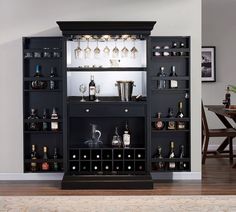 an entertainment center with wine glasses and liquor bottles