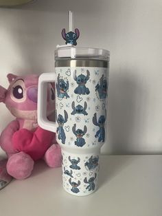 the cup is next to a pink stuffed animal