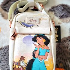 Disney Princess Jasmine Crossbody Bag. Super Nice With A Large Zipper Compartment And A Smaller Zipper Compartment On The Front. It Has An Adjustable Strap And Is Made Of A Soft Leather. Disney Style Shoulder Bag With Removable Pouch, Disney Crossbody Bags For Disney Trips, Disney Style Crossbody Bags For Disney Trips, Disney White Travel Shoulder Bag, Disney Style White Shoulder Travel Bag, Crossbody Shoulder Bag For Disney Trips, Loungefly Collection, Minnie Mouse Purse, Nightmare Before Christmas Backpack