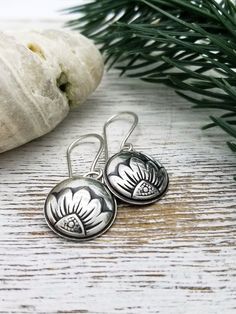 These sweet little silver flower earrings are sure to become your new grab-n-go pair! A little bit romantic, a little bit whimsical ... they are sure to brighten up any outfit you choose to wear them with. I impress this delicate floral pattern into sterling silver sheet metal to form a domed circle. Then I solder them to an open sterling silver backing to give them a little more substance yet still keeping them lightweight. I add a patina, hand polish them to a soft luster and suspend them on h Earrings Cottagecore, Cottagecore Jewelry, Bohemian Style Jewelry, Silver Flower Earrings, Sunflower Earrings, Bohemian Accessories, Jewelry Dainty, Etsy Bridesmaid Gifts, Daisy Earrings