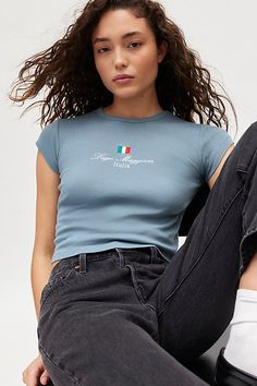 Well-traveled baby tee featuring embroidered Lago Maggiore, Italia graphics across the chest. Designed in a shrunken, slim fit with a crew neckline and mini cap sleeves for a demeur vibe. Features Italia embroidered graphic baby tee Fitted graphic tee Soft & stretchy knit Crew neckline with mini cap sleeves Lago Maggiore, Italia embroidered graphics at the chest Shrunken, slim fit Cropped length Easy pull-over style UO exclusive Content + Care 100% Cotton Machine wash Imported Size + Fit Model i Women's Graphic Tees, Vintage Graphic Tees, Graphic Baby Tee, Baby Graphic Tees, Graphic Tees Vintage, Blue Fits, Vintage Graphic, Edgy Look, Tees For Women