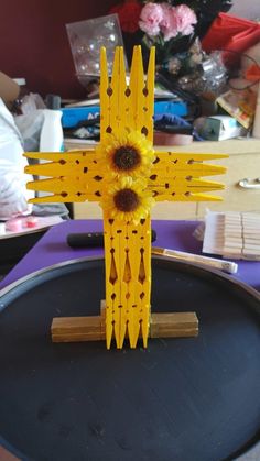 a cross made out of construction paper with a sunflower on it's center piece