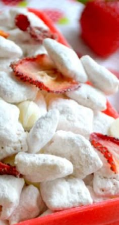 a red bowl filled with marshmallows and strawberries