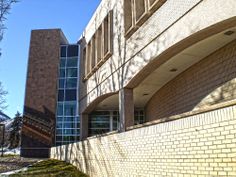 a brick building with a clock on the side