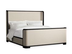 a bed with white linens and black trim on the headboard, in front of a white background