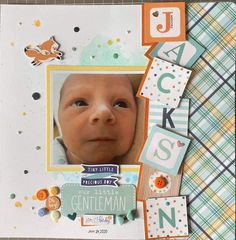 a scrapbook page with a baby's face and name on the front cover