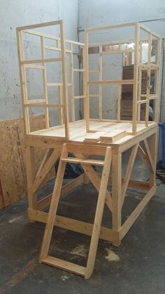 a wooden chair sitting on top of a table in a room filled with unfinished furniture