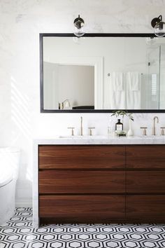 a bathroom vanity with two sinks and a large mirror