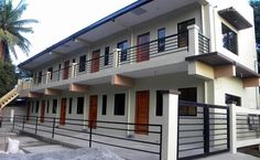 two story house with balcony and balconies on the second floor