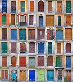 many different colored doors are stacked on top of each other in the same wall pattern