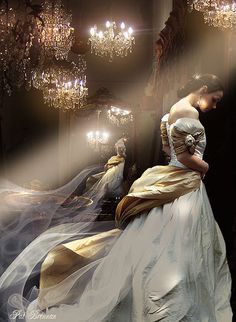 a black and white photo of a woman in a ball gown with chandeliers