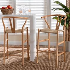 two chairs sitting next to each other in front of a table with fruit on it