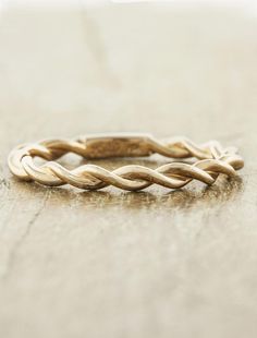 a gold ring sitting on top of a wooden table