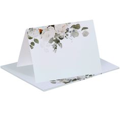 a white greeting card with flowers on it