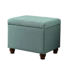 a blue ottoman sitting on top of a white floor