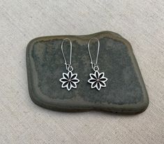 "Here are some very cute and pretty little flower dangle earrings. They have incredible detail and design. These earrings are lightweight and versatile, perfect for everyday wear. The earrings measure 5/8\" long by 5/8\" wide and hang from a 1\" kidney style ear wire that latches closed. Overall drop length is 1 3/4\". Made from allergy free plated silver. I have a matching necklace in my shop, if you would like the whole set. Here is a direct link https://etsy.me/3up3HSo Thanks for stopping by! Hypoallergenic Flower-shaped Earrings For Everyday Wear, Everyday Hypoallergenic Flower-shaped Earrings, Everyday Flower Charm Drop Earrings, Everyday Drop Earrings With Flower Charm, Everyday Flower Earrings For Pierced Ears, Everyday Earrings With Flower Charm, Pierced Drop Flower Earrings For Everyday, Everyday Pierced Flower Drop Earrings, Dainty Flower Earrings With Ear Wire