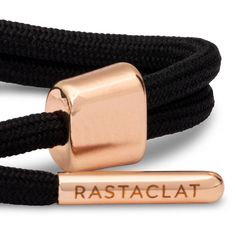 Black small Knotaclat bracelet featuring rose gold electroplated hardware and contrast emblems. -100% Polyester-One size fits most wrists, 4.5" to 6" wrist circumference 1% of net proceeds from all Rastaclat sales are donated to the Seek The Positive Foundation. Modern Adjustable Rose Gold Bracelets, Modern Bracelet With Adjustable Cord, Adjustable Rose Gold Bracelets, Modern Adjustable Braided Bracelets, Modern Adjustable Braided Bracelet, Adjustable Formal Bracelets, Adjustable Modern Braided Bracelet, Modern Adjustable Cord Bracelet, Luxury Adjustable Braided Bracelet For Formal Occasions