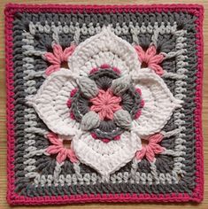 a crocheted square with flowers on it