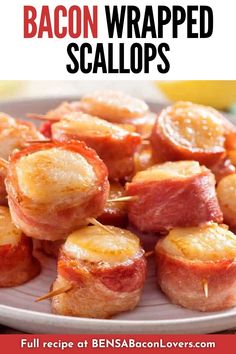 bacon wrapped scallops on a plate with lemon wedges