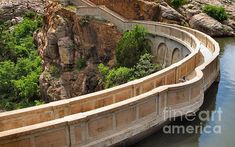 a bridge that is next to a body of water with stairs going up the side