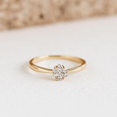 a diamond ring sitting on top of a white surface