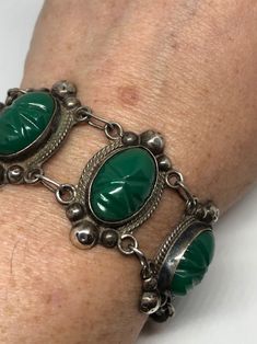 Ornate Green Bracelet Jewelry, Silver Carved Jade Jewelry, Carved Silver Jade Jewelry, Vintage Carved Jade Jewelry, Spiritual Silver Jewelry With Intaglio, Spiritual Silver Intaglio Jewelry, Antique Green Carved Jewelry, Unique Carved Bracelet Jewelry, Spiritual Carved Oval Jewelry