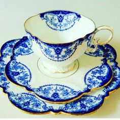 a blue and white tea set with matching saucers