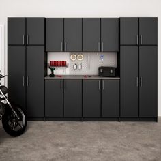 a motorcycle parked next to a garage with cabinets on both sides and a bike in the middle