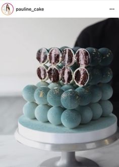 there is a cake that has blue and white frosting on it with chocolate candies in the middle