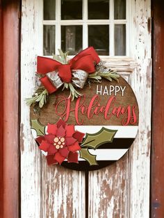 a wooden sign that says happy holidays with poinsettis and holly on it