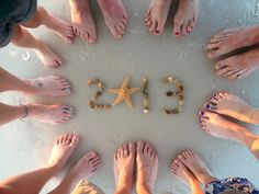 many people are standing in a circle with their feet on the floor and letters spelling out