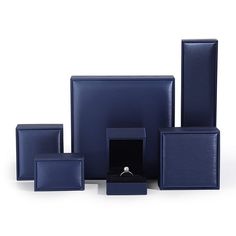 a set of blue boxes with a ring in the middle and other items around it