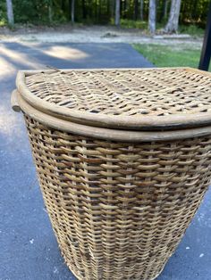 two wicker baskets sitting on top of each other in front of a park bench