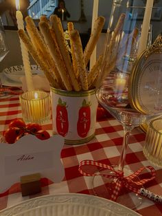 the table is set with plates, glasses and candles