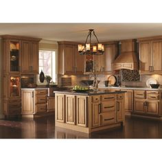 a kitchen with wooden cabinets and an island in the middle of the room is shown