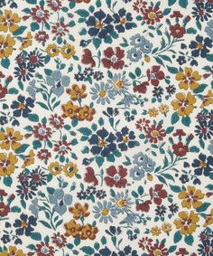 a white and blue floral print fabric with red, yellow, orange, and blue flowers