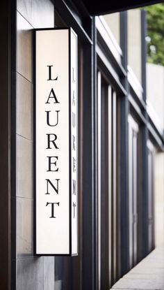 a sign on the side of a building that says laurenn in black and white