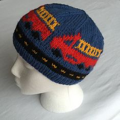 a knitted hat on top of a mannequin's head, with the word super hero written across it