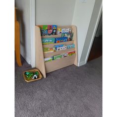 a child's bookshelf sitting on the floor in front of a door