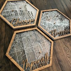 three wooden coasters sitting on top of a table next to each other with the names of different cities