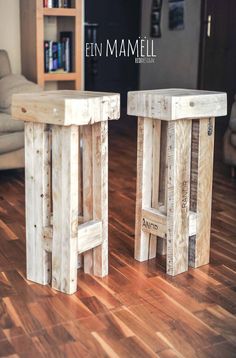 two wooden stools sitting on top of a hard wood floor